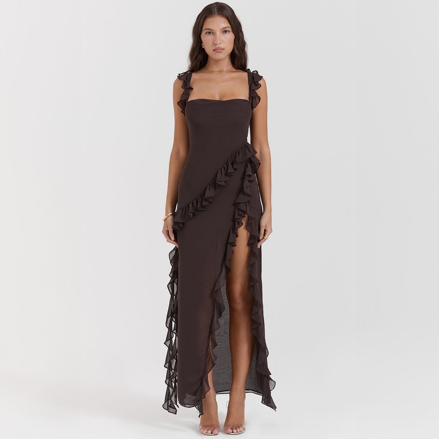 Abito lungo elegante nero con volant, spacco laterale, senza maniche. Perfetto per eventi serali e cerimonie. Moda donna, abbigliamento formale.